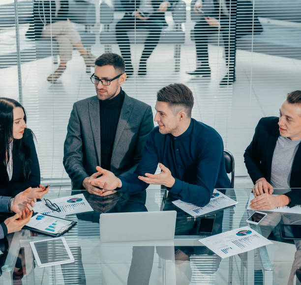 istock business colleagues talking about their ideas at a work meeting 1294657310