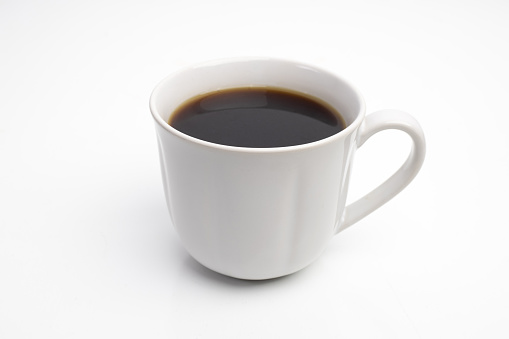 Top view of blue cup of tasty cappuccino with latte art on wooden table background