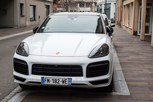 Mulhouse - France - 5 January 2021 - Front view of white Porsche Cayenne, the famous german suv parked in the street