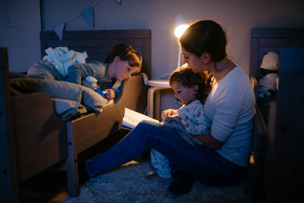 istock Young mom is reading fairytale book to her two boys 1294662406