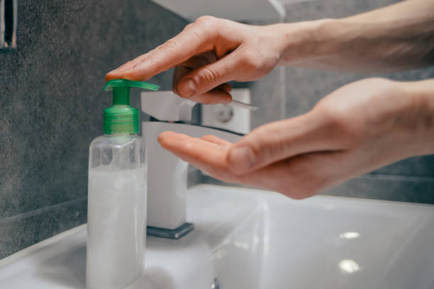 istock close up. modern guy washes his hands in the bathroom 1294662722