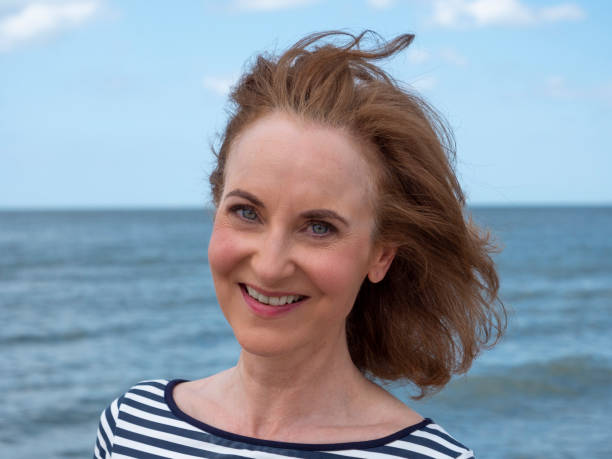 istock Smiling mature woman at beach. 1294670140