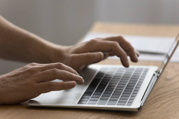 istock Close up of man typing on modern laptop keyboard 1294670726