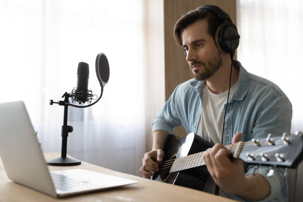 istock Young male artist learn playing guitar online 1294670744