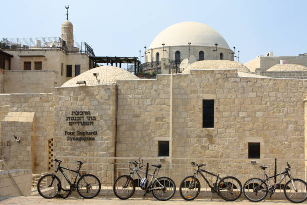 four sephardi synagogues in jerusalem with mosque minaret in background - sephardi imagens e fotografias de stock