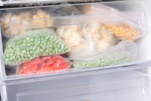 istock Plastic bags with different frozen vegetables in refrigerator 1294673269