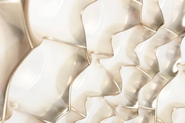 istock Golden background made of plastic packaging for candy.  Perforated packaging design. 1294674773