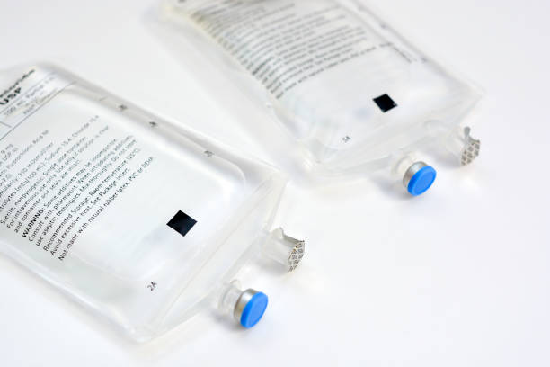 Two Sodium Chloride IV Bags two saline IV bags side by side on white background saline drip stock pictures, royalty-free photos & images