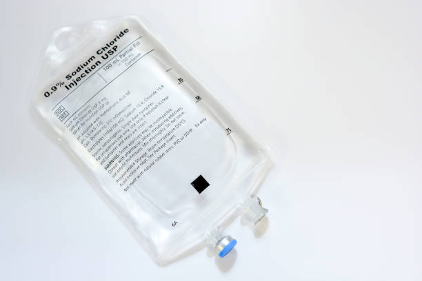 One Sodium Chloride IV Bag Single saline IV bag isolated on white background saline drip stock pictures, royalty-free photos & images