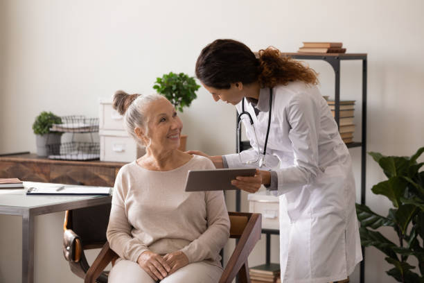 istock Female doctor consult senior patient using tablet 1294678915