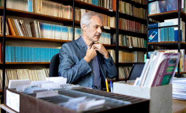 istock University professor in library stock photo 1294680571