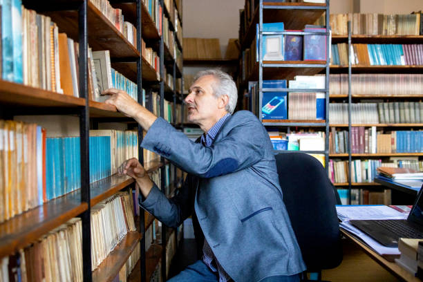 istock University professor in library stock photo 1294680683