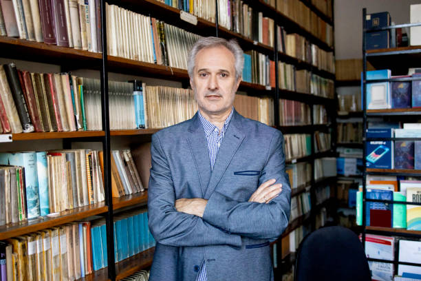 istock University professor in library stock photo 1294680744