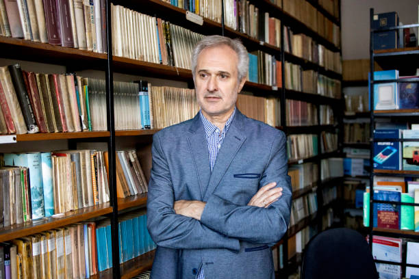 istock University professor in library stock photo 1294680959