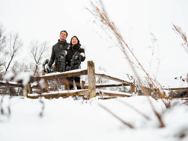 istock Mixed race couple snowshoeing in winter 1294682353