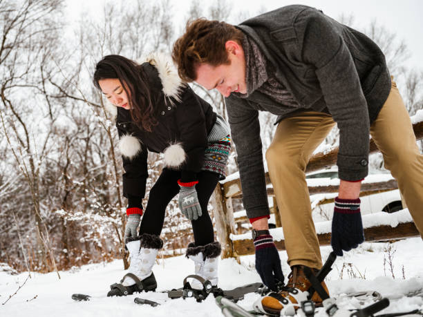 istock Mixed race couple snowshoeing in winter 1294682380