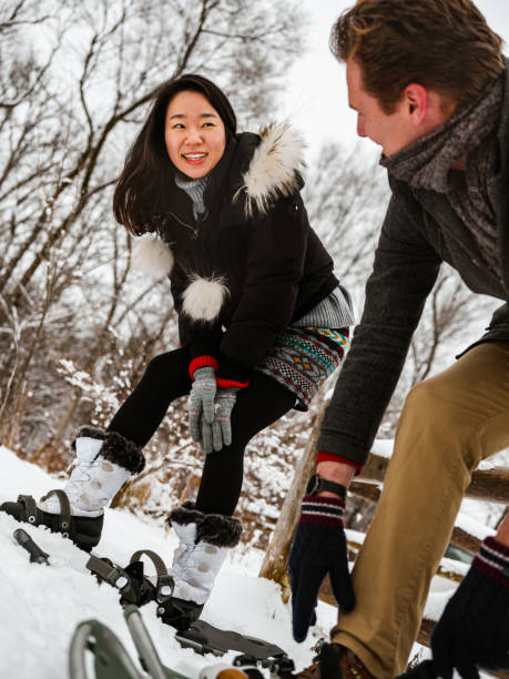 istock Mixed race couple snowshoeing in winter 1294682688
