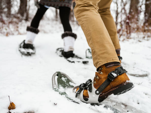 istock Mixed race couple snowshoeing in winter 1294682771