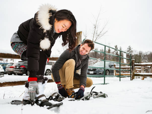 istock Mixed race couple snowshoeing in winter 1294682837