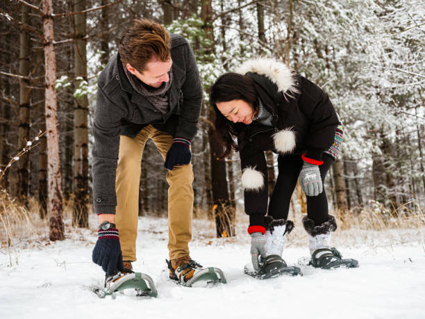istock Mixed race couple snowshoeing in winter 1294683003