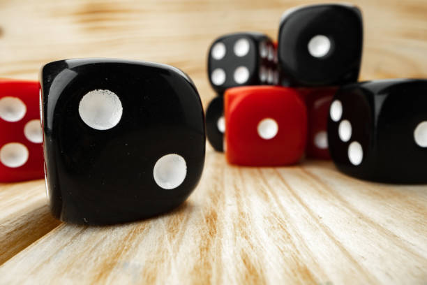 istock Red and black dice cubes on wooden background 1294686145