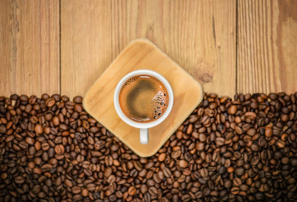 Coffee Cup and Roasted Coffee Beans on Wooden Table