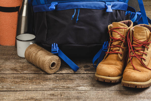 istock Blue backpack and hiking boots. Mountain gear close up 1294690143