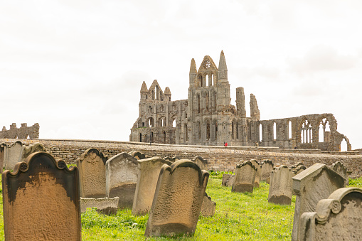 Whitby, England 02.05.2019 - Whitby Abbey ruins in North Yorkshire and Graveyard in foreground