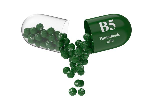 istock Open capsule with pantothenic acid from which the vitamin composition is pouring 1294691914