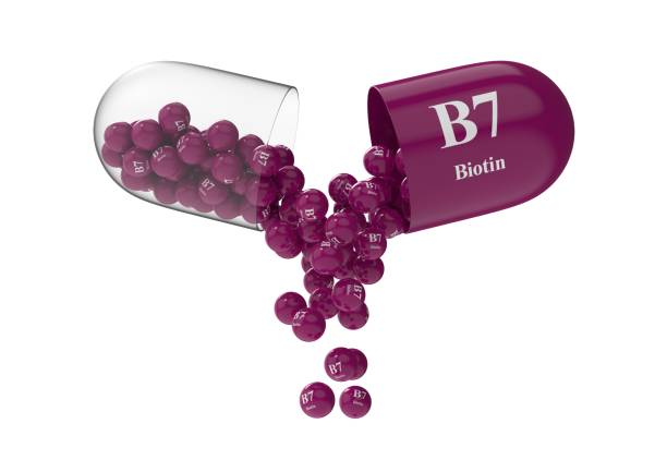 istock Open capsule with biotin from which the vitamin composition is pouring 1294691935