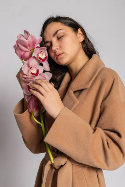 istock Seductive blonde woman in brown jacket posing in studio 1294695491