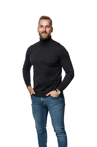 Smiling blonde man in long-armed sweater, standing against a white background.