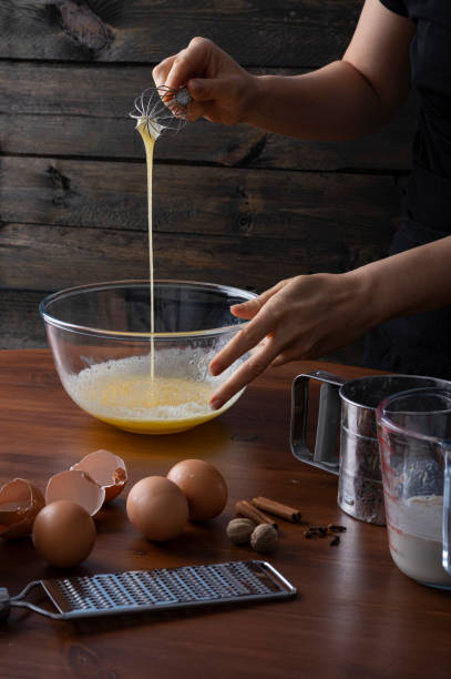 istock A woman whisking eggs and spices in a bowl at a cottage kitchen 1294700896