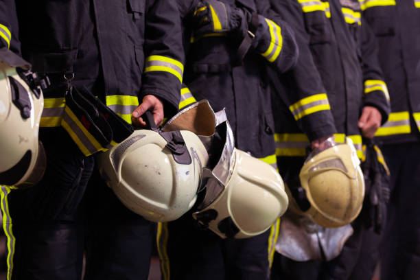 istock Abstract professional firefighters wearing uniforms and protective helmets 1294703830