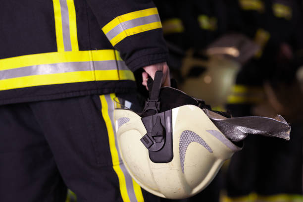 istock Abstract professional firefighters wearing uniforms and protective helmets 1294703850