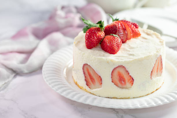 istock Delicious cheesecake with fresh strawberries without baking on a marble stone table 1294704276