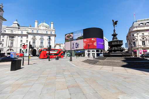 London, UK - Feb 22, 2018: Tourists enjoying the ride on an open-air double decker Tour Bus in London.