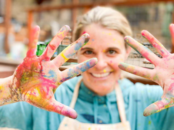 istock Children paint, create, and work on art with their teacher outside. 1294710910