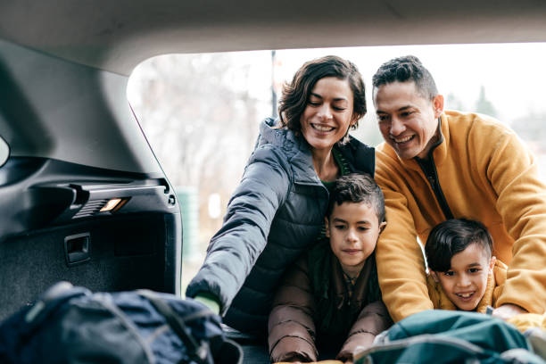 istock Family going to road trip and loading a car with backpacks 1294711177