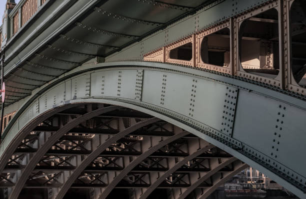 Side view of Beams and Rivets-structure under the Bridge span in the setting sun.