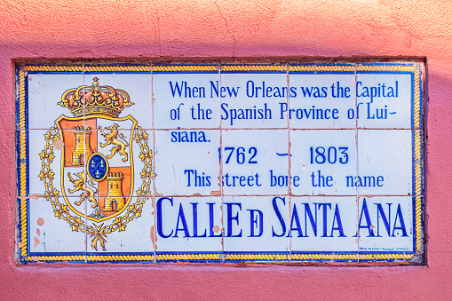 Ceramic tile street name sign of Calle de Santa Ana street in old town New Orleans Louisiana USA on a sunny day.