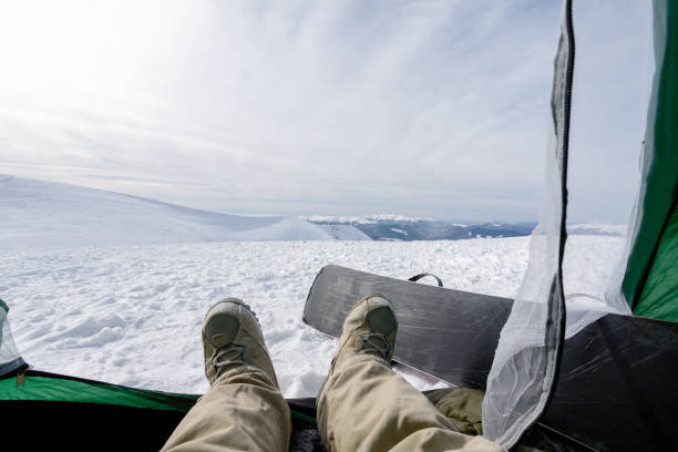 istock Snowboarder lies in tent 1294715879