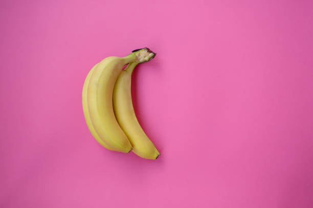 istock Single banana on a pink background with strong shadow 1294717872