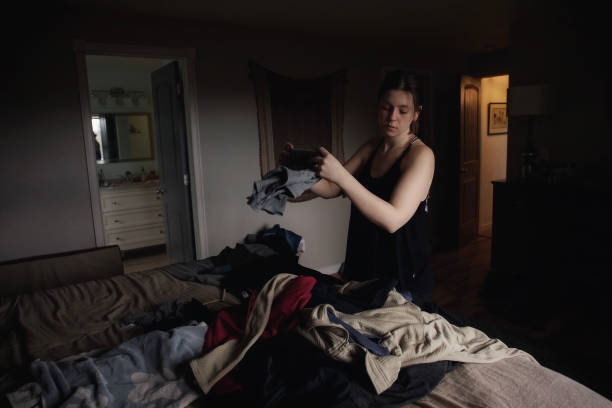 istock Woman folding laundry in bedroom 1294718778