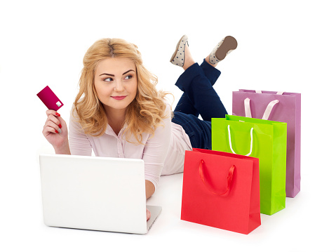Young girl with shopping bags and laptop