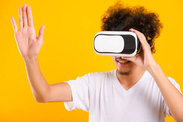 istock Asian handsome man with curly hair he using virtual reality headset or VR glass 1294738842