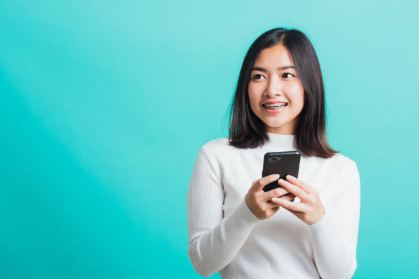 istock woman smile she holding and typing text message 1294738880