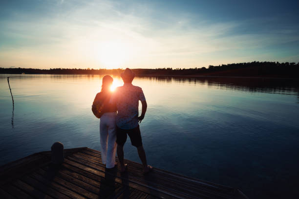 Asian middle aged couple standing at coast