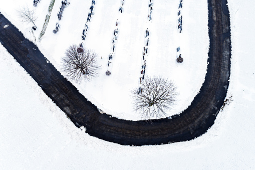 Looking down on a cemetery covered with fresh snow.