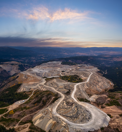 Aerial view from Airplane of a Mining Facility in the interior British Columbia, Canada. Sunset Sky.
